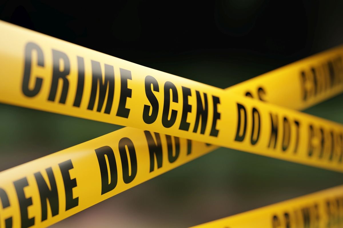 Crime Scene Tape Barrier In Front Of Defocused Background