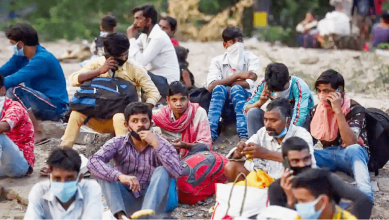 Migrant sit on Road_0
